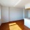 a room with a wood floor and windows