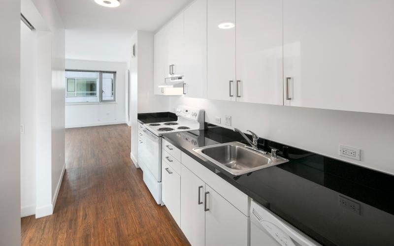 a kitchen with white cabinets