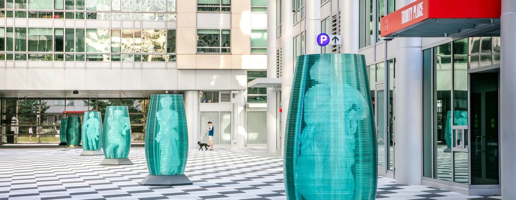 a large metal cylinder in front of a building